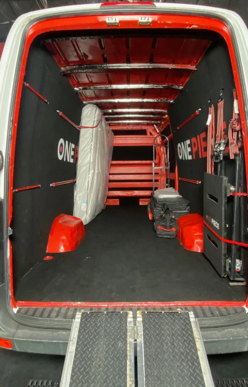 Inside a One Piece Delivery Sprinter van, with straps, dollies, blankets and a ramp